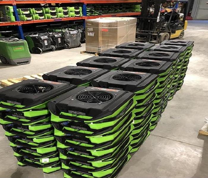 A photo of SERVPRO's green Air Movers stacked up to go to a home