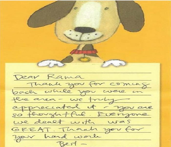 A handwritten thank you note on dog-themed stationary