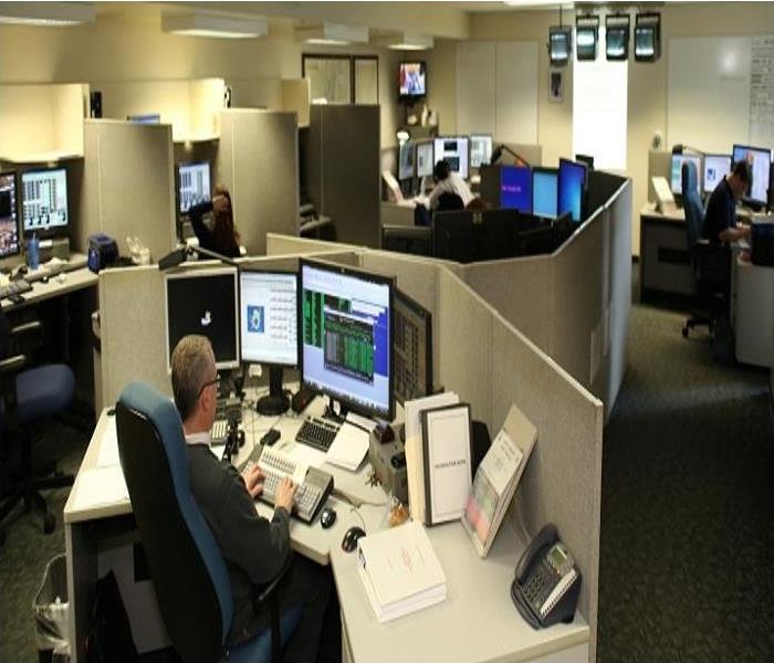 An interior photo of a call center with multiple desks and computers