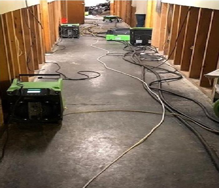 Drying equipment set up around water damaged walls