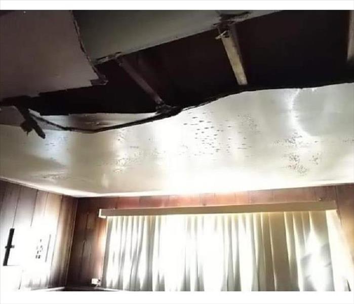 A ceiling collapse inside a living room of a home.